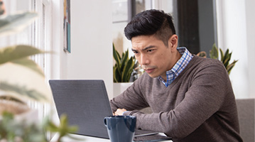 man looking at a laptop